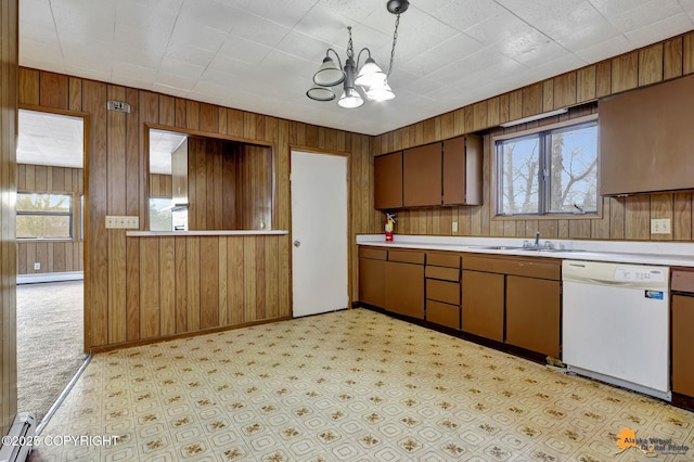 kitchen featuring a sink, baseboard heating, white dishwasher, and light countertops