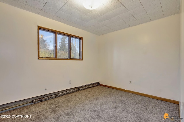 carpeted spare room featuring baseboards