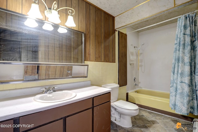 full bath with toilet, shower / bath combo, stone finish flooring, a chandelier, and vanity