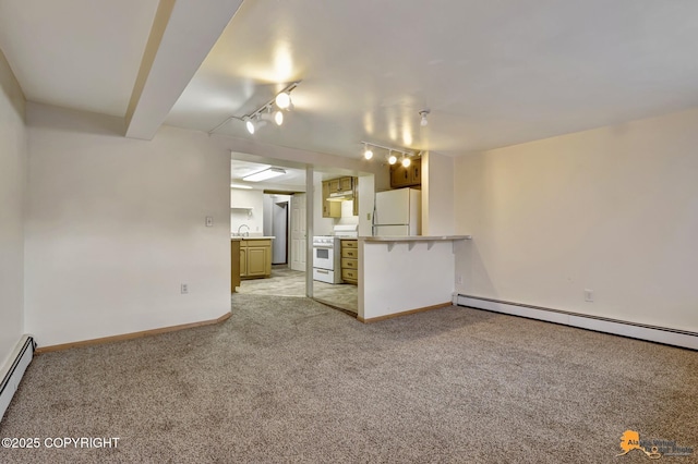 unfurnished living room featuring track lighting, light carpet, baseboards, and a baseboard radiator