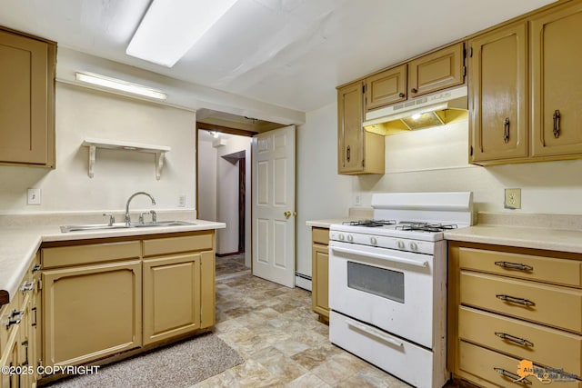 kitchen featuring under cabinet range hood, white range with gas cooktop, light countertops, and a sink