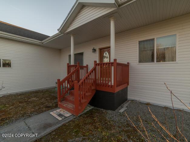 view of exterior entry featuring a porch