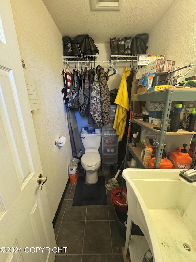 bathroom featuring tile patterned flooring, a textured ceiling, and sink