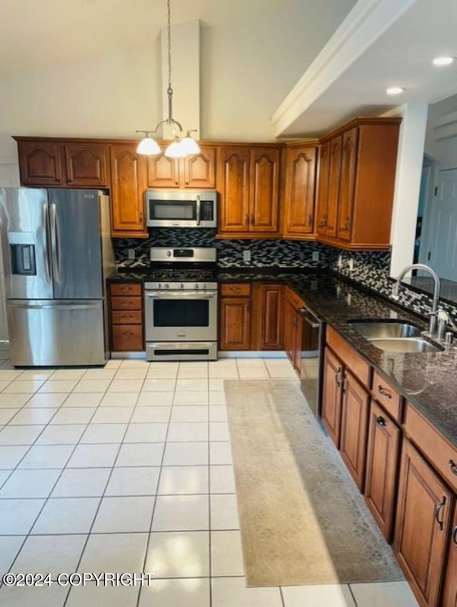 kitchen with sink, decorative light fixtures, a notable chandelier, light tile patterned flooring, and stainless steel appliances