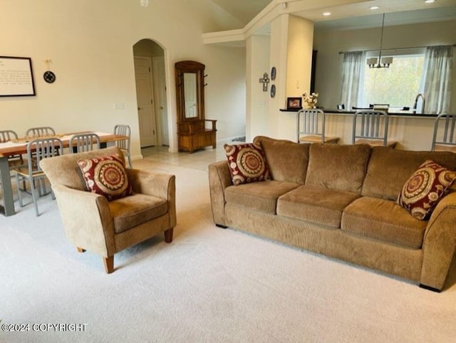 living room with a notable chandelier and light carpet