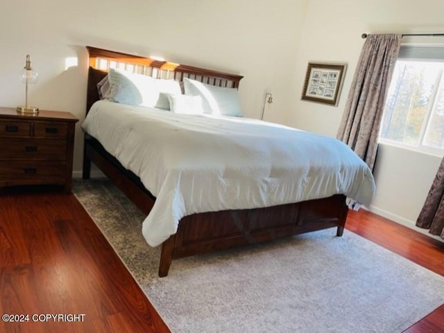 bedroom with dark wood-type flooring