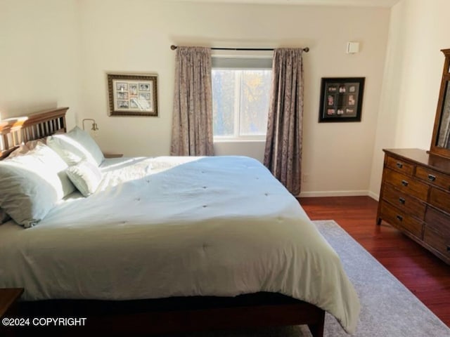 bedroom featuring dark hardwood / wood-style flooring