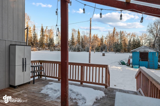 snow covered deck with a storage unit