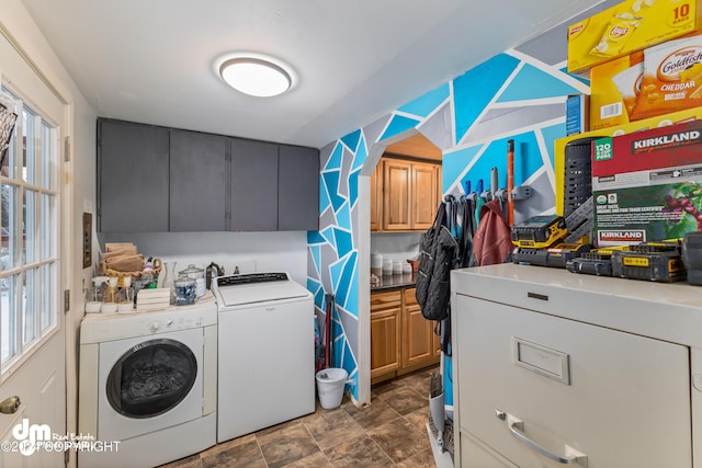 washroom with washer and clothes dryer and cabinets