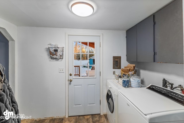 laundry area featuring cabinets, dark hardwood / wood-style flooring, and separate washer and dryer