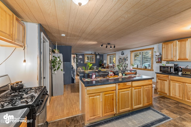 kitchen featuring dark hardwood / wood-style flooring, range with gas stovetop, track lighting, a kitchen island, and wood ceiling