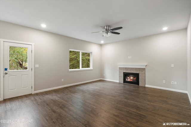 unfurnished living room with a ceiling fan, a fireplace, dark wood finished floors, recessed lighting, and baseboards