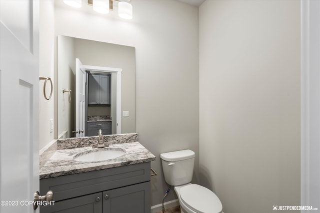 bathroom with toilet and vanity