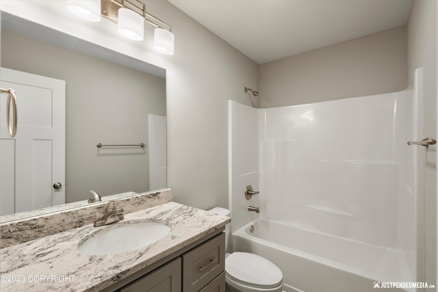 full bathroom featuring toilet, bathing tub / shower combination, and vanity