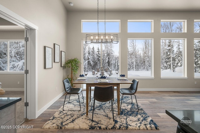 dining room with a chandelier and dark wood-type flooring