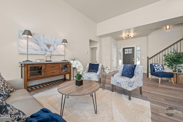 living room featuring hardwood / wood-style flooring and vaulted ceiling