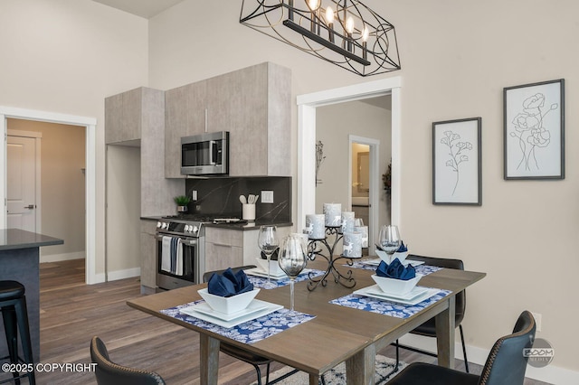 dining room featuring dark wood-type flooring and a notable chandelier