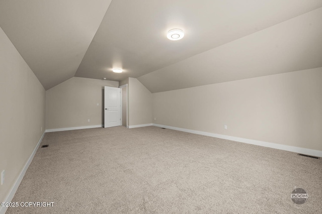 additional living space with carpet and vaulted ceiling