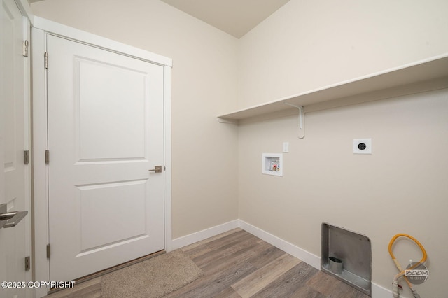 washroom with hookup for an electric dryer, wood-type flooring, and hookup for a washing machine