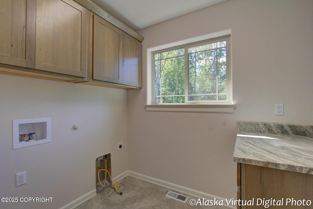 washroom featuring cabinets, washer hookup, hookup for a gas dryer, and electric dryer hookup