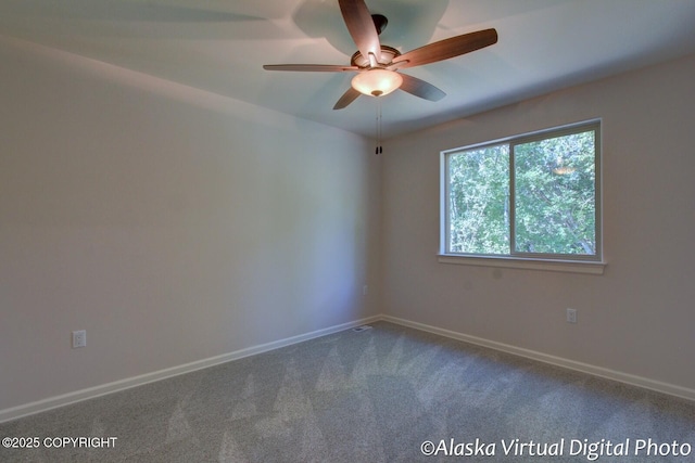 carpeted spare room featuring ceiling fan