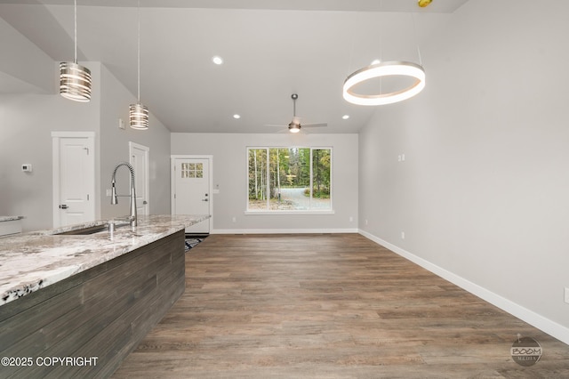 L12 Jasmine Rd, Chugiak, AK 99567 - kitchen featuring lofted ceiling, a sink, a ceiling fan, baseboards, and decorative light fixtures