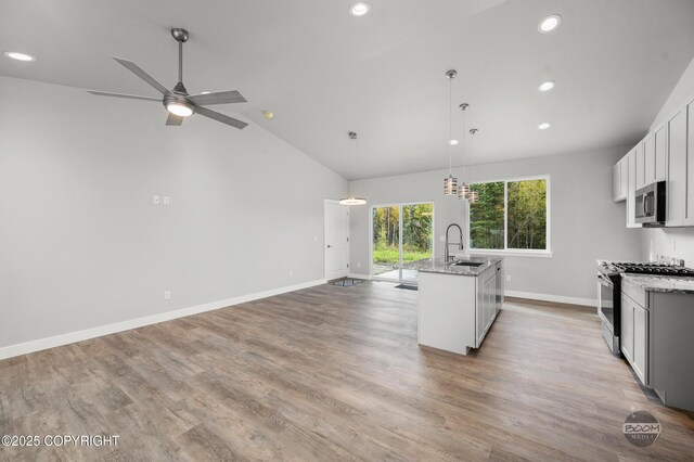 L12 Jasmine Rd, Chugiak, AK 99567 - kitchen with range with gas stovetop, stainless steel microwave, a sink, recessed lighting, and baseboards