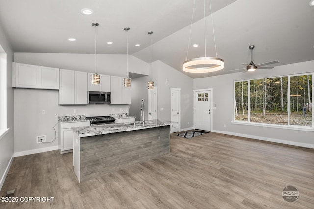 L12 Jasmine Rd, Chugiak, AK 99567 - kitchen with stainless steel appliances, white cabinets, a sink, a kitchen island with sink, and recessed lighting