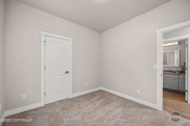 L12 Jasmine Rd, Chugiak, AK 99567 - unfurnished bedroom with carpet, baseboards, and a sink