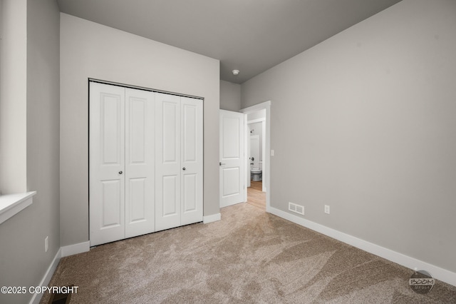 L12 Jasmine Rd, Chugiak, AK 99567 - unfurnished bedroom featuring carpet flooring, baseboards, and a closet