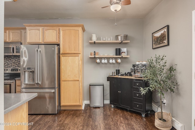 kitchen with appliances with stainless steel finishes, dark wood-type flooring, a baseboard radiator, and light brown cabinetry