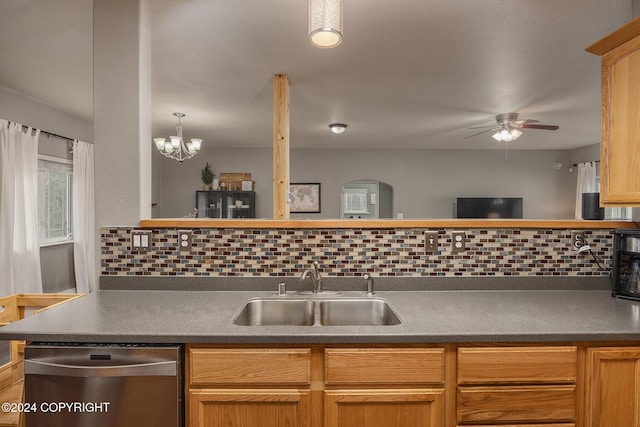 kitchen featuring pendant lighting, dishwasher, backsplash, ceiling fan with notable chandelier, and sink