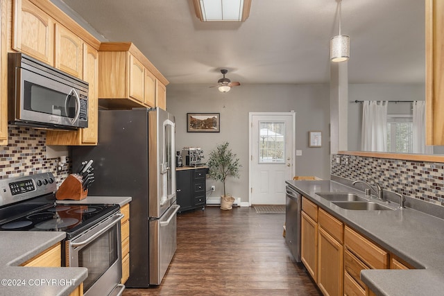 kitchen featuring pendant lighting, a wealth of natural light, sink, and appliances with stainless steel finishes