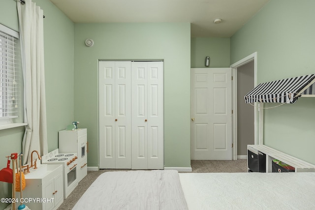 bedroom with light colored carpet and a closet