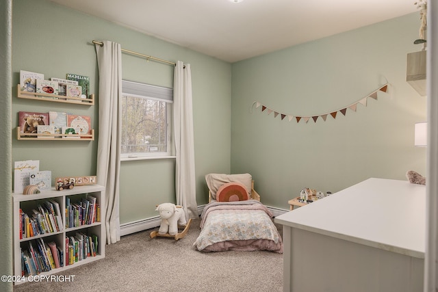 bedroom with carpet floors and a baseboard heating unit