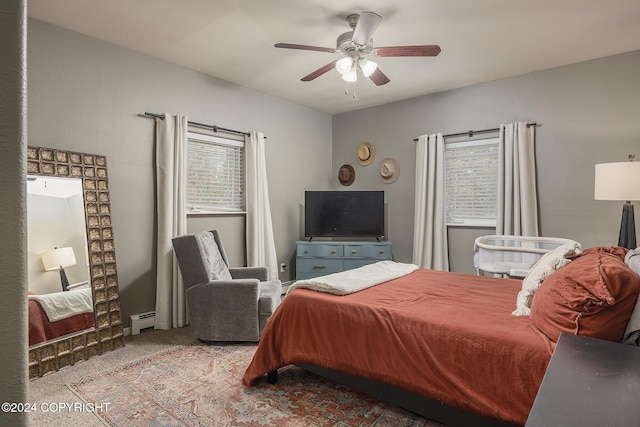 carpeted bedroom with ceiling fan and a baseboard radiator