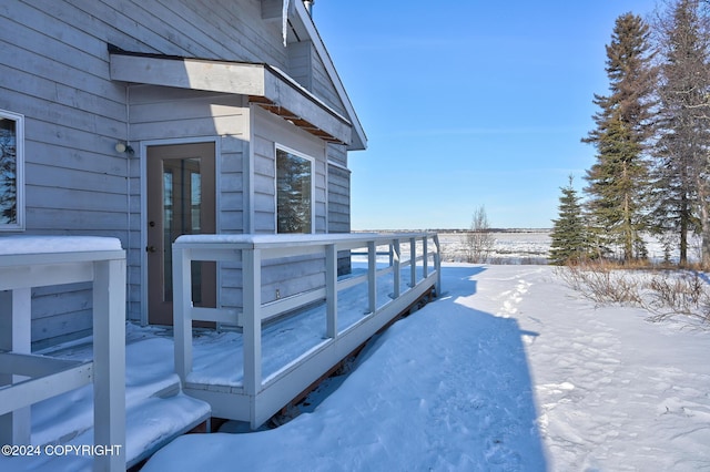 view of snowy exterior featuring a wooden deck