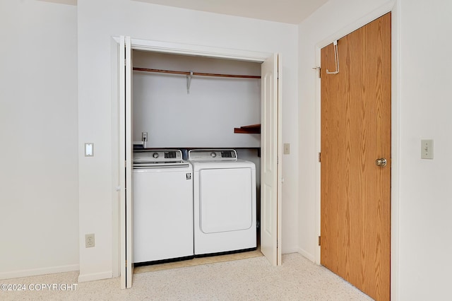 clothes washing area with washing machine and clothes dryer