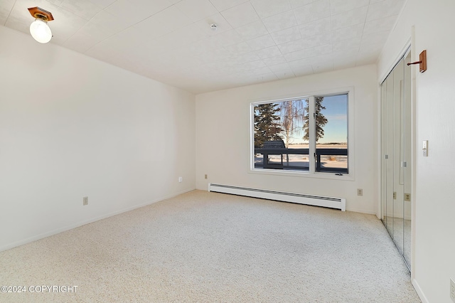 empty room featuring a baseboard heating unit