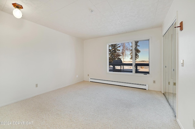 2795 Watergate Way, Kenai, AK 99611 - empty room featuring a baseboard radiator, light carpet, and a pendent fire sprinkler