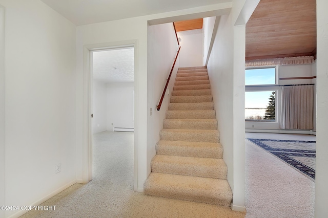 stairway featuring a baseboard radiator