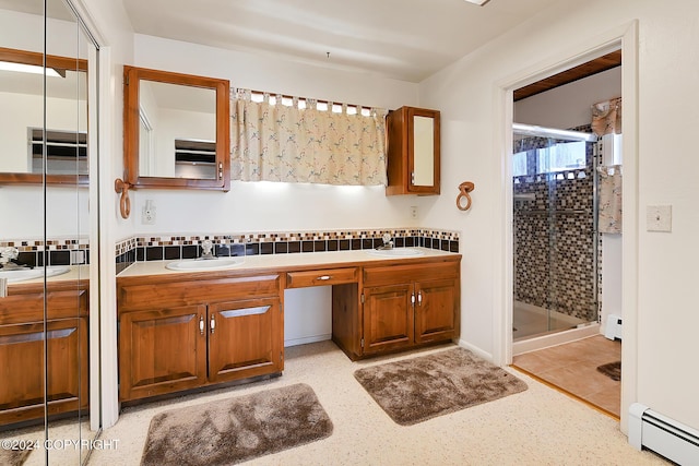 2795 Watergate Way, Kenai, AK 99611 - full bath featuring baseboard heating, double vanity, a shower stall, a baseboard heating unit, and decorative backsplash