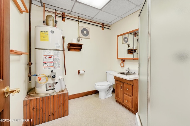 bathroom featuring vanity, a drop ceiling, gas water heater, and toilet