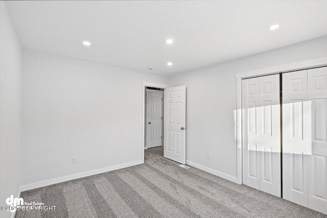 unfurnished bedroom featuring carpet floors and a closet