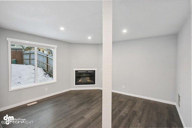 unfurnished living room with dark hardwood / wood-style flooring