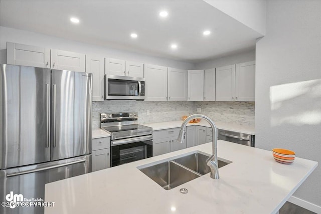 kitchen featuring decorative backsplash, sink, and stainless steel appliances