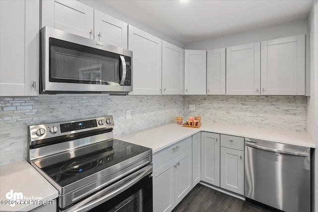 kitchen featuring white cabinets, backsplash, and stainless steel appliances