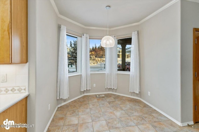 unfurnished dining area featuring light tile patterned flooring and crown molding