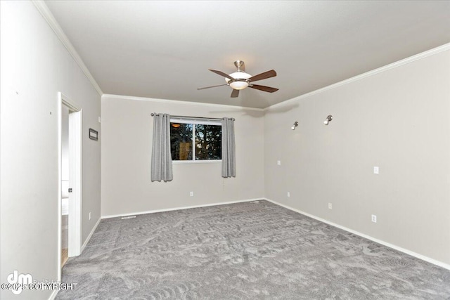 carpeted empty room featuring ceiling fan and ornamental molding