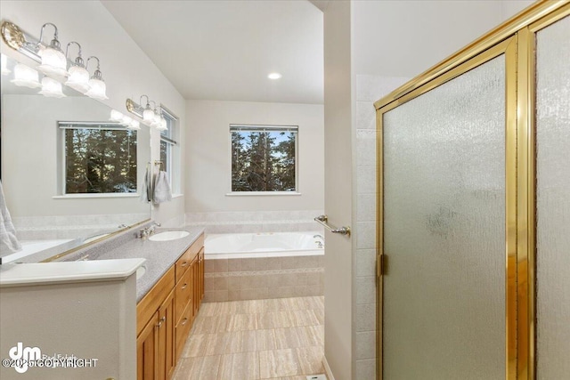 bathroom featuring plus walk in shower and vanity